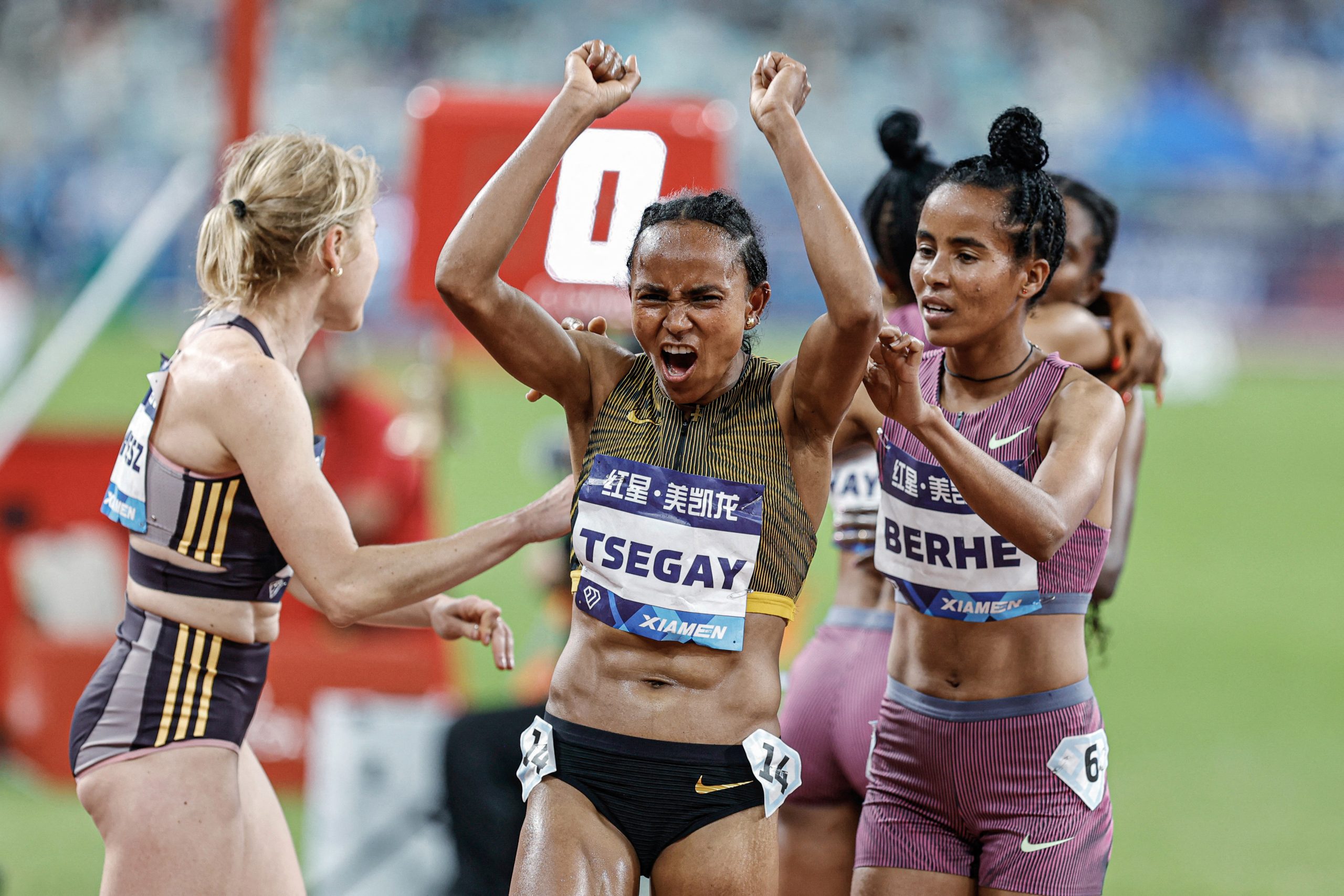 Ethiopia's Gudaf Tsegay (C) celebrates after winning the 1500m women event during the Xiamen IAAF Diamond League athletics meeting at Egret Stadium in Xiamen, in China's eastern Fujian province, on April 20, 2024. 