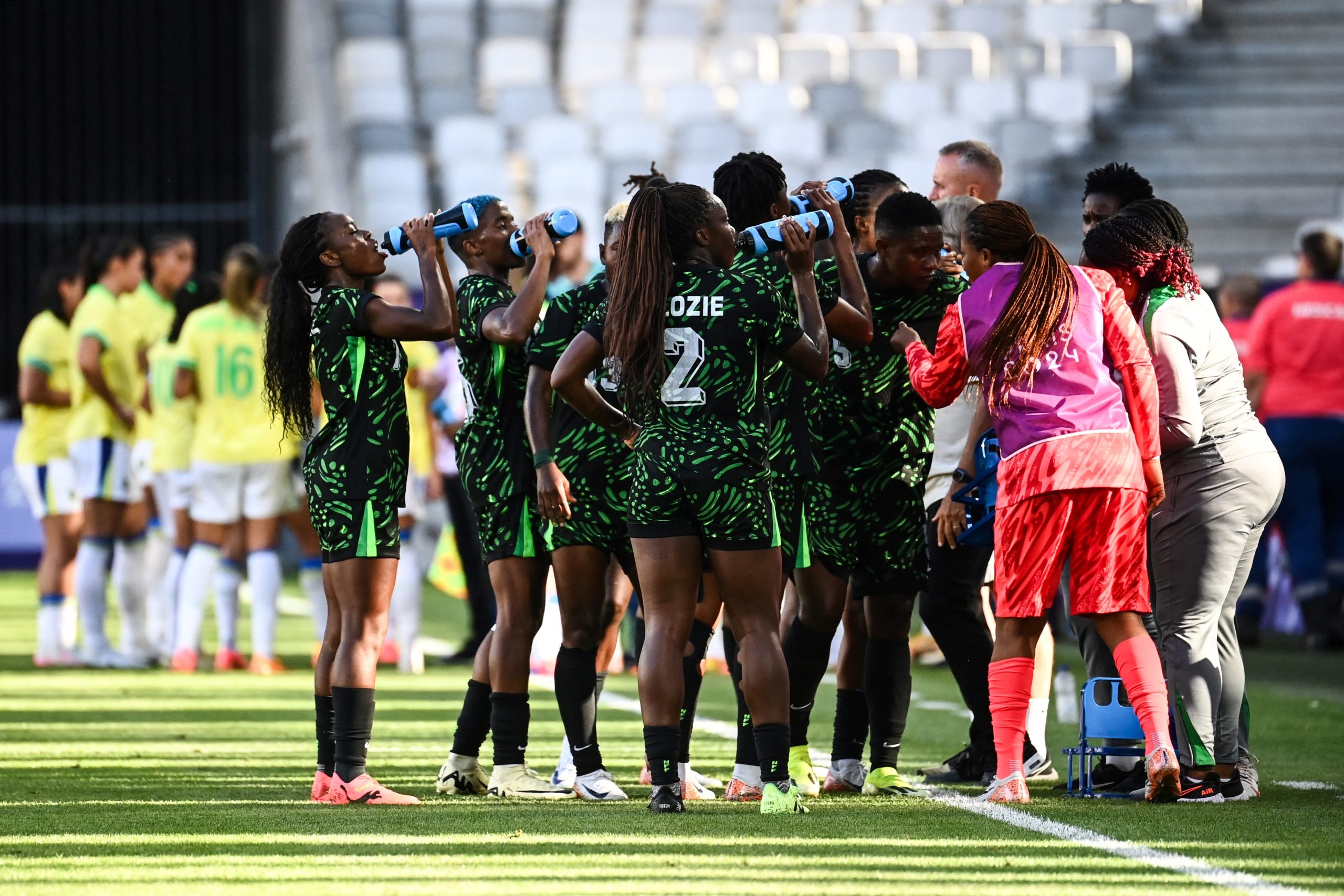 Nigeria's teammates drinks during a water break during the Paris 2024 Olympic Games women's group C football match between Nigeria and Brazil at the Bordeaux Stadium, in Bordeaux, on July 25.