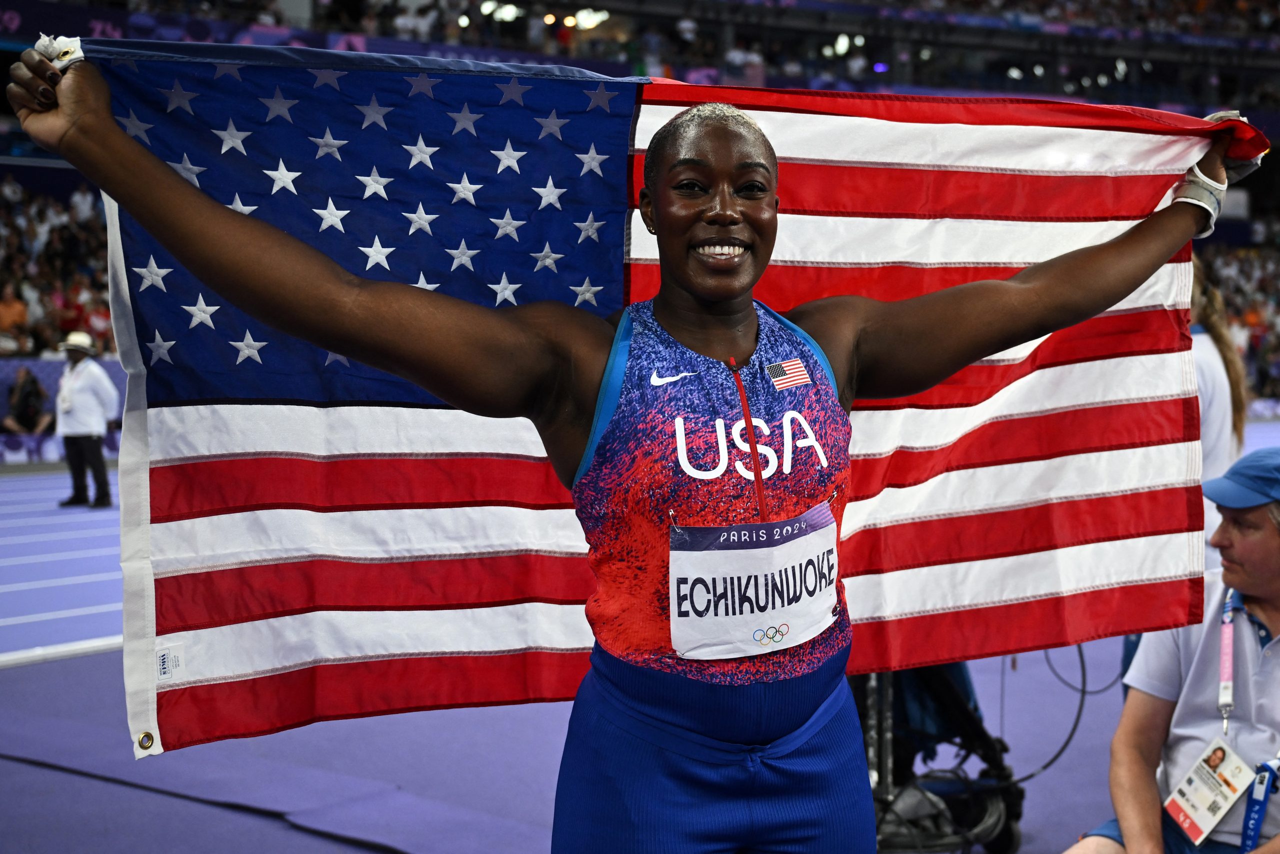 Silver medallist US' Annette Nneka Echikunwoke celebrates with the national flag after competing in the women's hammer throw final of the athletics event at the Paris 2024 Olympic Games at Stade de France in Saint-Denis, north of Paris, on August 6, 2024.